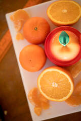fresh oranges on white plate at yellow background