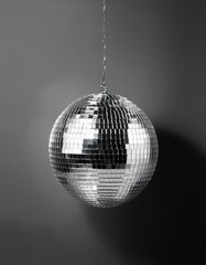 Obraz premium Disco ball hanging from a chain on a wall