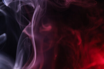 Fototapeta premium Red and white lines, vibrant smoke on the black background, colourful abstract, line of light on black background, macro photography 