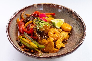 Pan-Asian Dish with Shrimp, Meat, Bell Peppers, Vegetables, and Sesame on a White Background