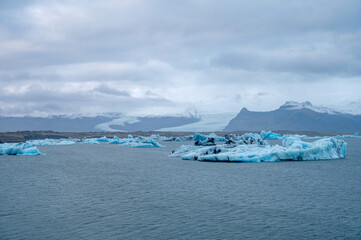 Scenic landscape of Jokulsarlon. Glacial lake in Iceland. Cloudy weather. Icelandic nature. Blue ice...