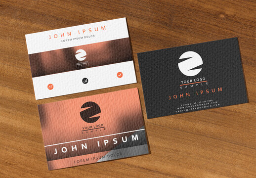Three Business Cards Placed on Wooden Surface for Branding Ideas
