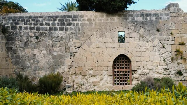 Slow motion panning video of an ancient arched window located in Bellapais, North Cyprus.