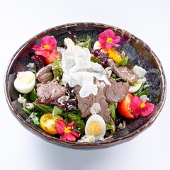 Hot Pan-Asian Salad with Meat, Egg, Greens, and Flower Garnish