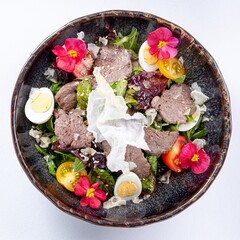 Hot Pan-Asian Salad with Meat, Egg, Greens, and Flower Garnish