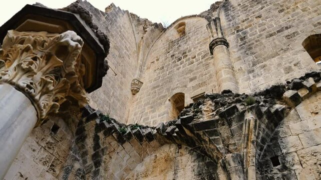 Slow motion panning video of an ancient column and arched ruins located in Bellapais, North Cyprus.