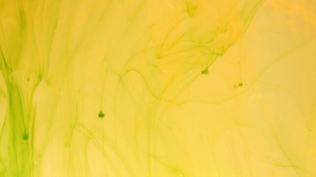 Green ink breaks up in water creating abstract structures, inky background