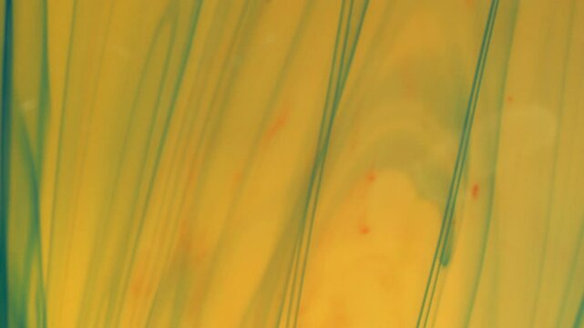 Abstract background. Colored streaks create structures under the influence of water.