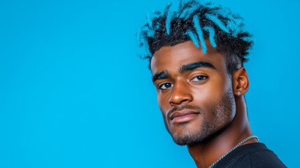 Obraz premium Man with blue hair and a beard stands in front of a blue background. He has a serious expression on his face
