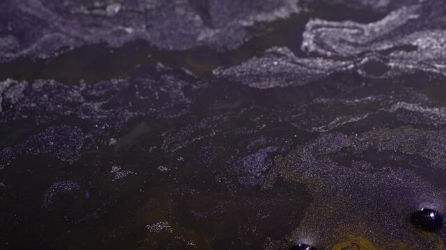 Flow of glitter liquid with dark navy shade.Abstract background