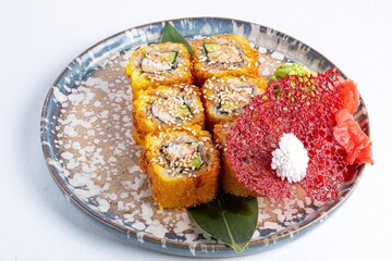Bright Japanese Yellow Sushi Rolls with Red Fish, Tuna, Ginger, and Wasabi