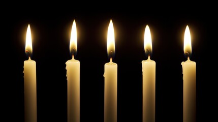 Five lit candles against a black background 