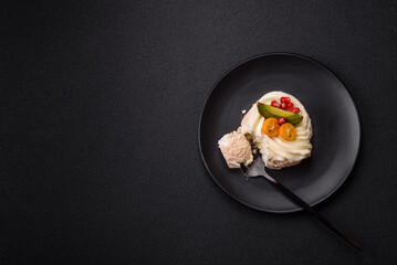 Piece of sweet meringue with citrus, kiwi and pomegranate seeds