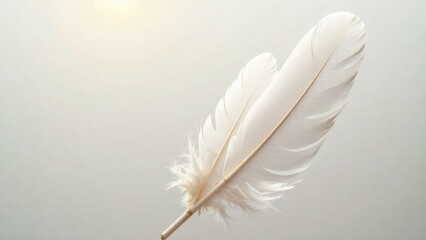 Obraz premium A delicate white feather is displayed gracefully against a soft gray backdrop, softly illuminated by ambient natural light. Generative AI