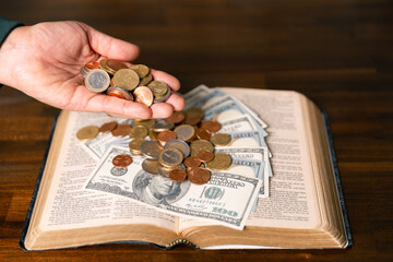 He decided to donate portion of his earnings as tithe, giving money and coins as contribution to...