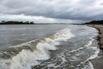 Fototapeta premium Stormy Seascape Waves Crashing on a Sandy Shore Under a Dramatic Sky