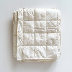 Obraz premium Folded white quilt on white background.