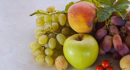 Grapes and various autumn fruits on the table
