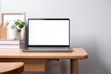 Fototapeta premium Open laptop with blank screen on a wooden desk in a home office