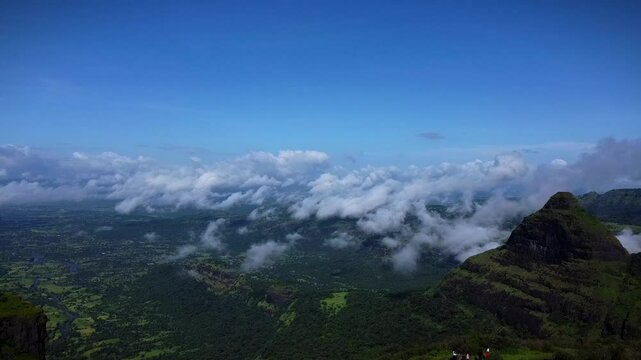 Aerial view of Tiger Point Lonavala with green landscape under clouds and blue sky