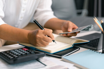 After inspecting finance documents and paperwork, he carefully calculated each tax deduction before...