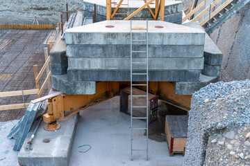 Ballast crane concrete weights on the crane construction. Ladder leaning against it. In the...