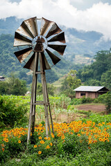 conceptual image windmill fan generate electricity in a small village generated by AI