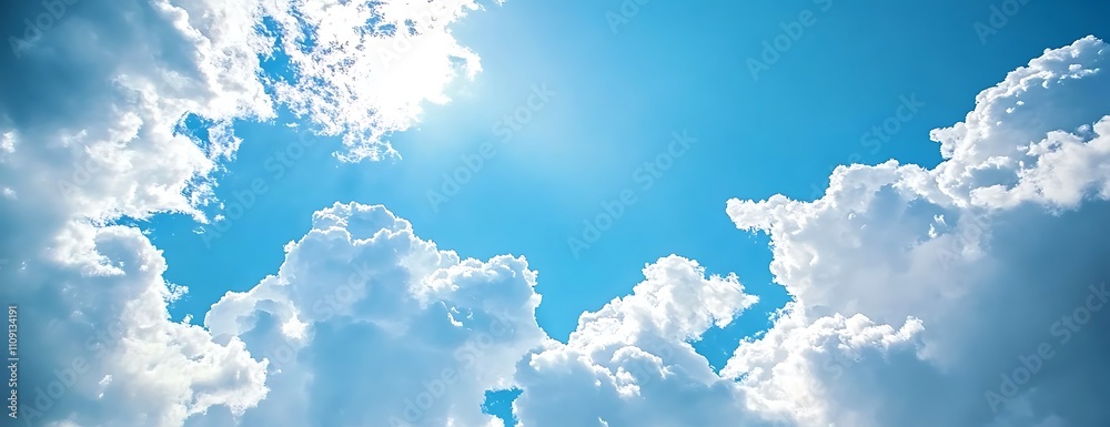 Poster a bright blue sky filled with fluffy white clouds, illuminated by sunlight, creating a serene and up