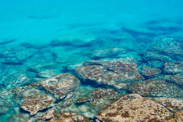 Reef rocks in a blue beach in Ayia Napa Cyprus. Crystal clear water of the beaches in Cyprus.