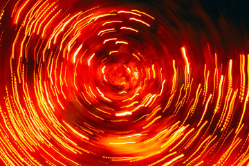 Orange energy swirl glowing lines forming a vortex. Concept of space travel, fast movement,...