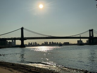 Fototapeta premium On a sandy beach with the Manhattan Bridge in the background Manhattan, New York, NY, USA