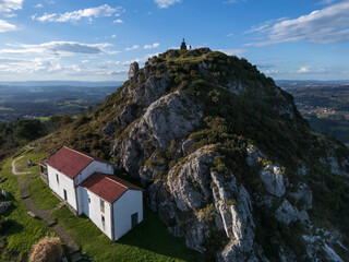 Naklejka premium Aerial view of the Pico Sacro mountain and the Chapel of San Sebastian del Pico Sacro in Boqueixon, Galicia