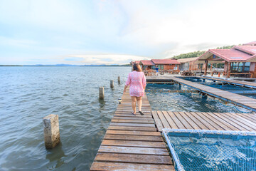 The background of the sea by the evening sea, with natural beauty (sea water, rocks, sky) and fishermen are fishing by the river bank, is a pleasure during travel.