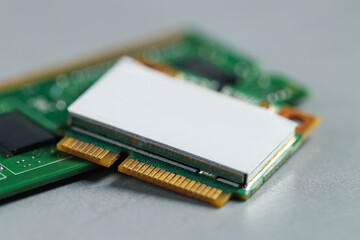 Wi-Fi card and RAM chip on grey table, closeup