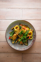 Top view of stir-fried seafood with spicy thai herbs, include with mussels, shrimps and squids