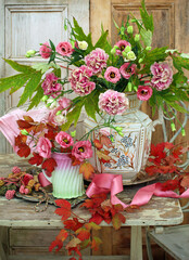 Still life of carnations and eustoma flowers in a decorative jugs on a rustic wooden table with...