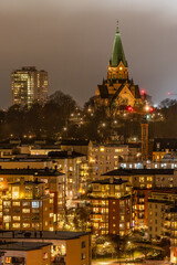 Fototapeta premium Stockholm, Sweden A night view of Sodermalm apartment buildings and the Sofia Church.