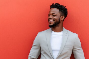 Happy Man Smiling Against Red Wall Wearing Grey Suit