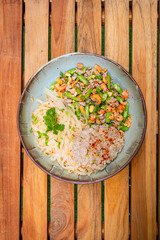 Top view of noodles mince pork with chili and thai herbs. Thai dish