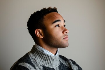 Obraz premium Young Man Contemplating in Profile Wearing a Sweater