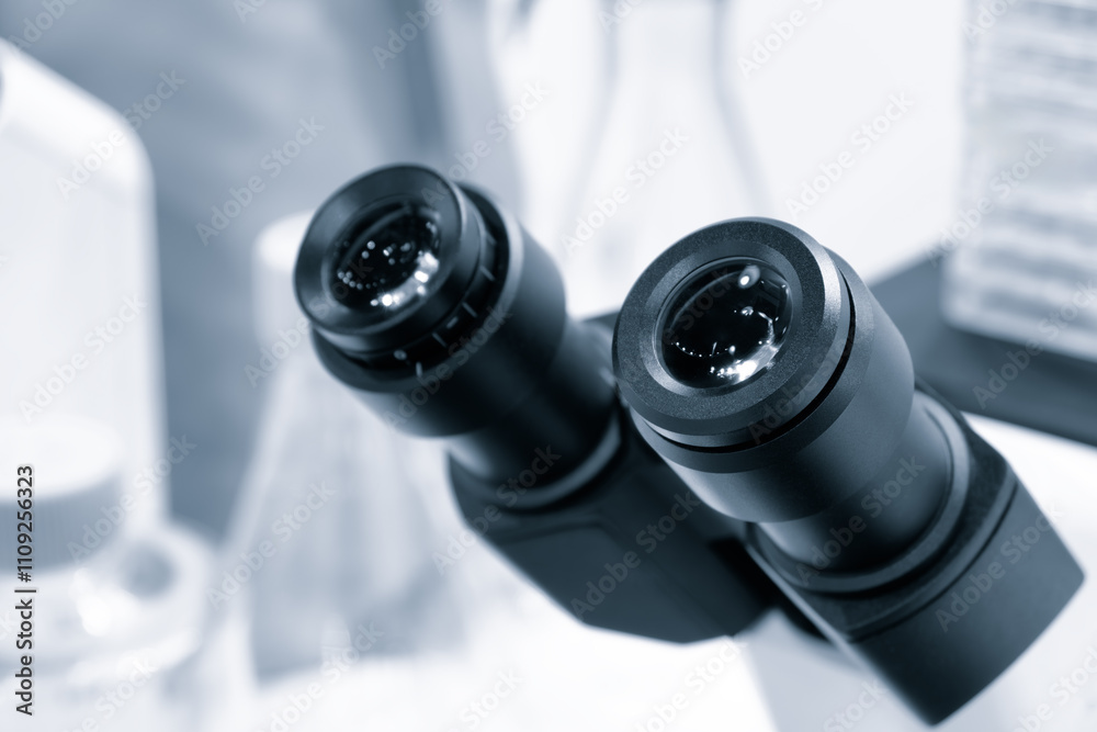 Poster two microscope eyepieces close-up in a laboratory