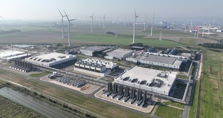Aerial view of windmills and Large data center in the Eemshaven - Powered by Adobe