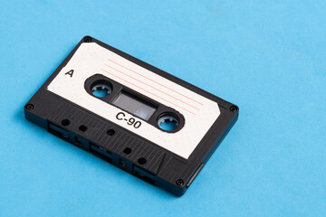 Obraz premium Old vintage audio cassette on blue background.