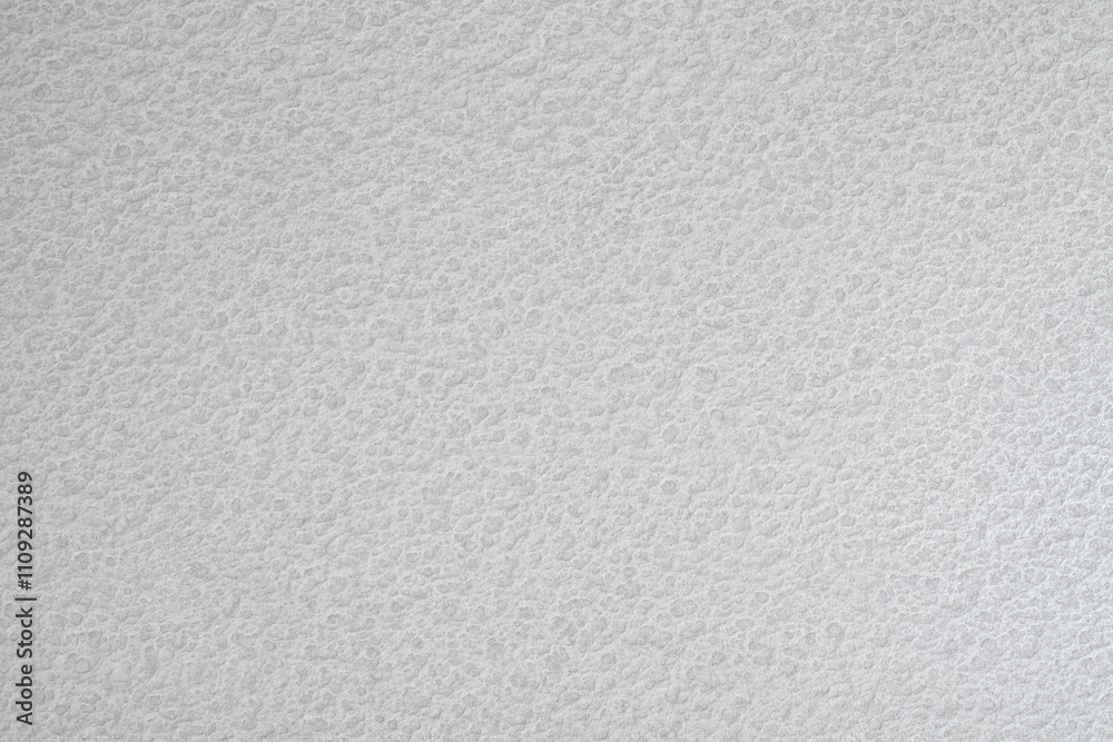 Aufkleber a white wall with a textured surface. the wall is covered in a pattern of small bumps white gray tex