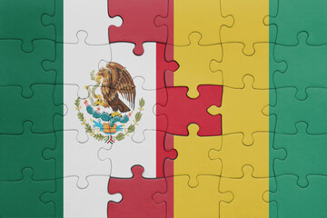 puzzle with the colourful national flag of guinea and flag of mexico .