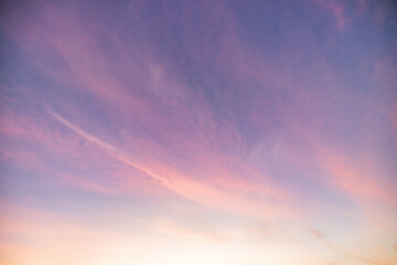 Obraz premium A beautiful sky tinted by the sun leaving vibrant shades of gold, pink, blue and multicolored. Clouds in the twilight evening and morning sky. Cloudy sky background in the evening, and during the day.
