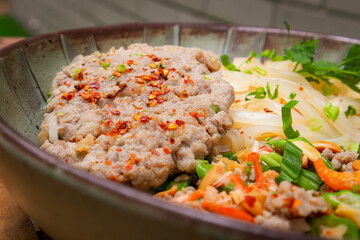 Close up of noodles mince pork with chili and thai herbs. Thai dish