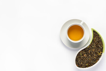 Blank photography of green tea with rose petals, jasmine flowers, strawberry and  mango slices, dry petals; healthy natural drink, indian, tea with herbs, caffeine