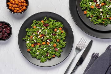 Food photography of salad with roasted crispy chickpeas, kale, dried cranberries and goat cheese, vegetarian meal, plant-based protein, dietary fibre