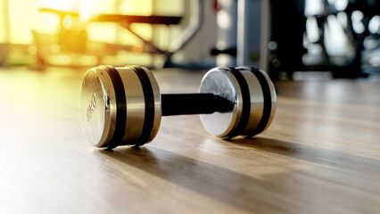Barbell or dumbbell in the gym at sunset